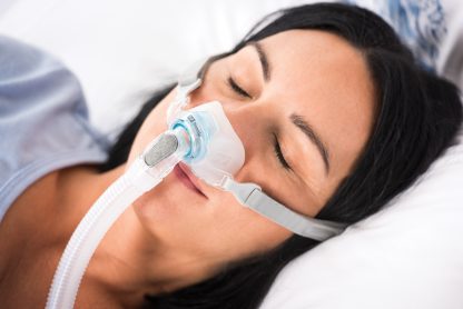 Woman Sleeping with CPAP Mask