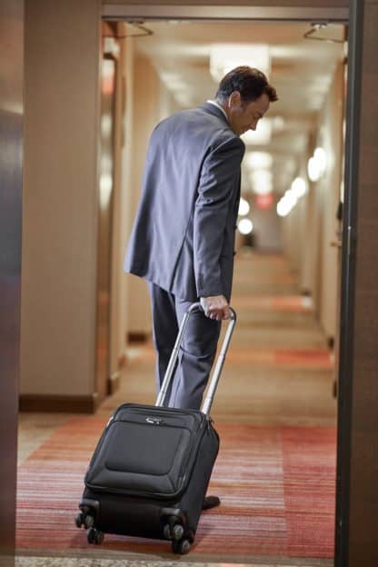 Man with Suitcase in Hotel - cpapRX